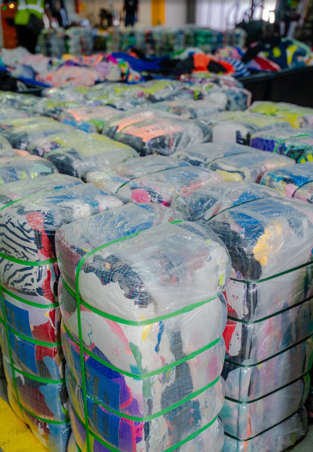 Clothing bales staged on the warehouse floor for loading